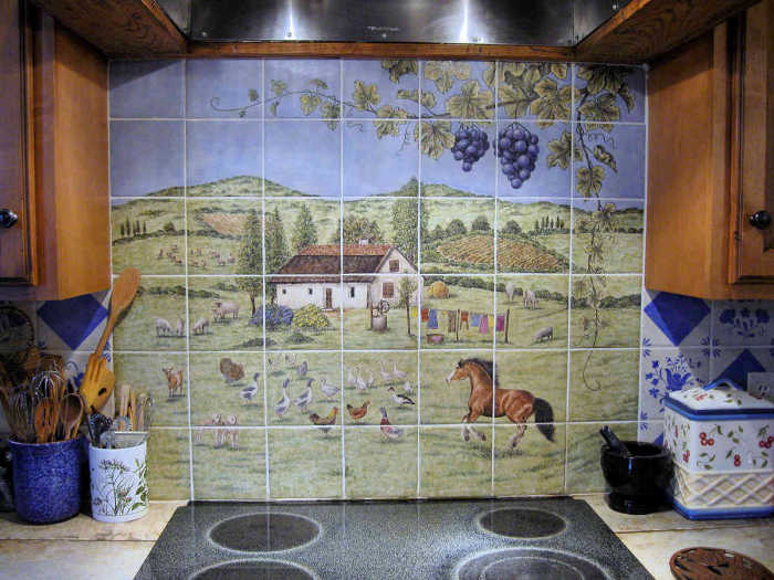 European Style Country Kitchen. Backsplash with its barnyard birds, sheep, goats and thatched roof cottage home. Painted tile mural by Julia Sweda.