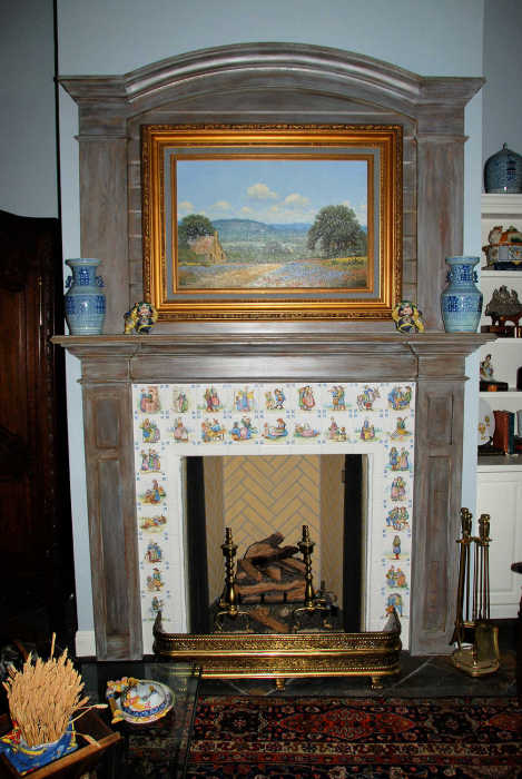 Quimper style tile art portraits installed as a decorative fireplace surround. Artist Julia Sweda.