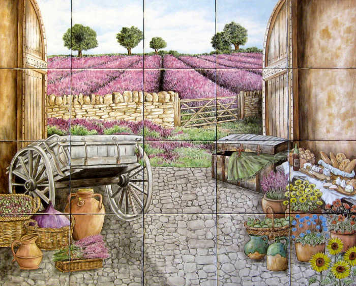 View looking through old barn at potted flowers, farm tools, organic produce, table of French wine, cheese, breads and blooming lavender field. Custom painted tile mural by Julia Sweda.